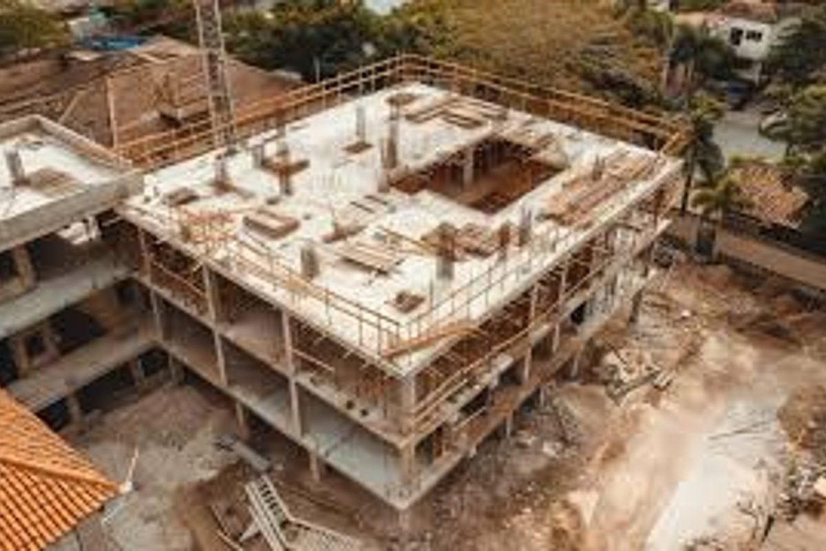 Aerial view of a reinforced concrete frame under construction with scaffolding.